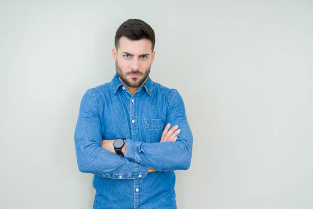 istock Young handsome man over isolated background skeptic and nervous, disapproving expression on face with crossed arms. Negative person. 1134252330