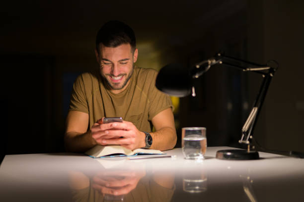 istock Young handsome man studying at home , using smartphone, looking at the phone smiling 1134253254