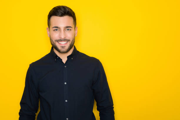 istock Young handsome man possing and modeling over yellow isolated background 1134253538