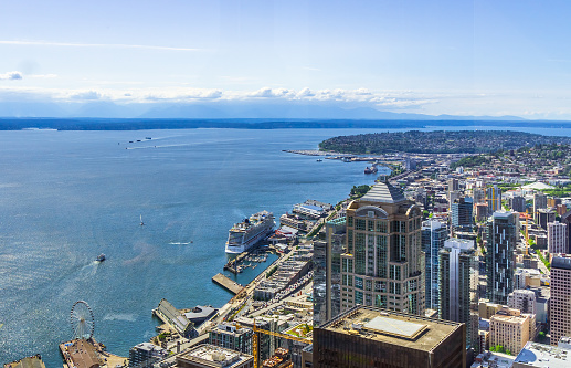 Aerial view of downtown Seattle districts, the waterfront and Elliott Bay on a sunny day. Seattle skyline, WA, USA.