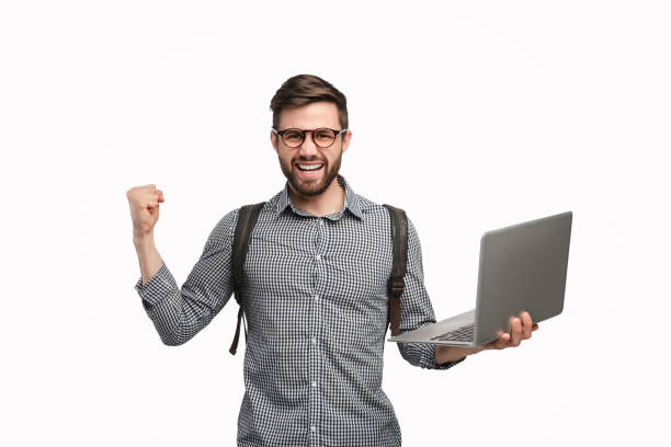 istock Excited man with backpack and laptop celebrating win 1134255253