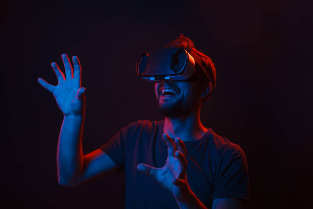 istock Amazed man in VR headset touching air 1134255286