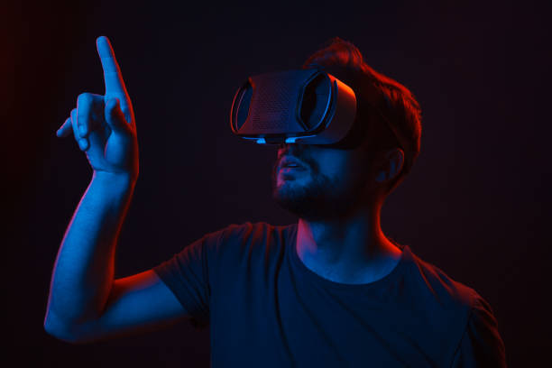 istock Man in VR glasses touching invisible screen 1134255287