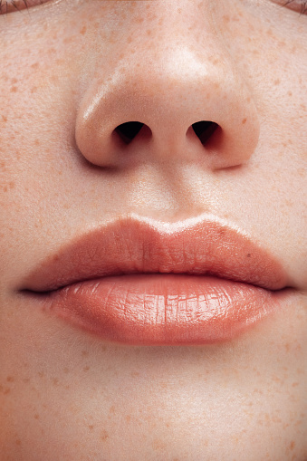 Parte de la cara de la mujer. Labios y nariz de la mujer. Piel blanda. photo