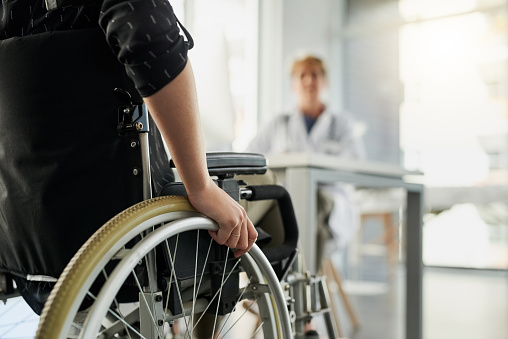 Cropped shot of an unrecognizable woman in a wheelchair visiting the doctor's rooms for a consultation