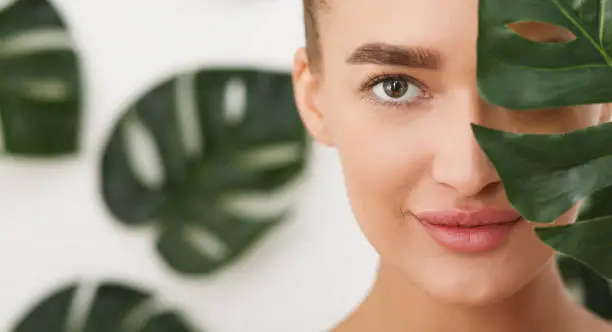 Photo of Woman with natural make up and green leaf