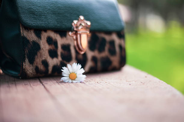 women bag and chamomile flowers low contrast women's day photo