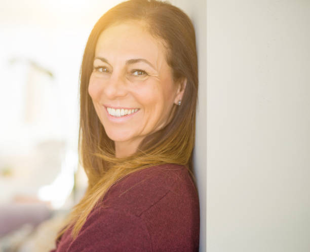 istock Beautiful middle age woman smiling at home 1134261612