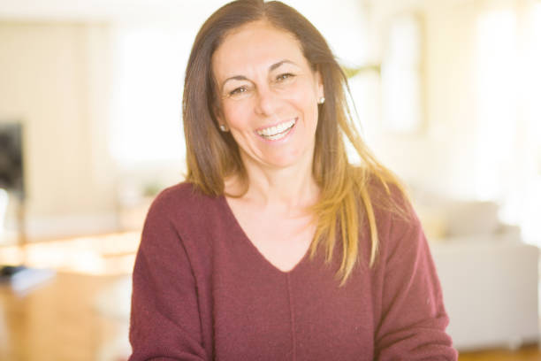 istock Beautiful middle age woman smiling at home 1134261698