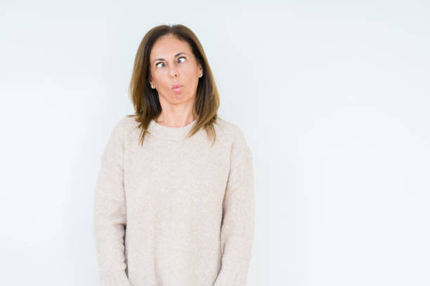 istock Beautiful middle age woman over isolated background making fish face with lips, crazy and comical gesture. Funny expression. 1134262142