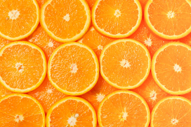 istock Slices of oranges as a background, top view. 1134263512