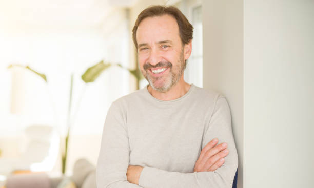 istock Handsome middle age man smiling looking at the camera at home 1134264114