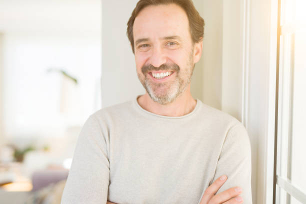 istock Handsome middle age man smiling looking at the camera at home 1134264160