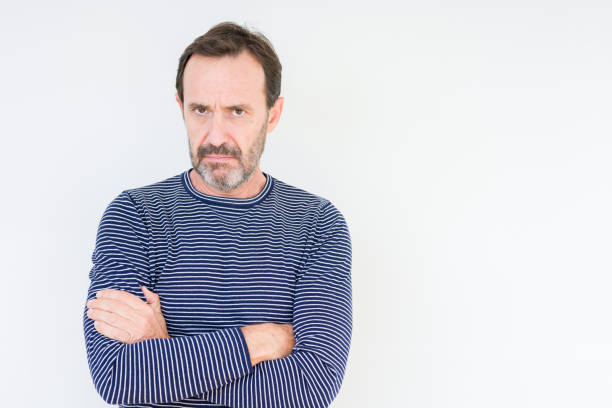 istock Handsome senior man over isolated background skeptic and nervous, disapproving expression on face with crossed arms. Negative person. 1134264209