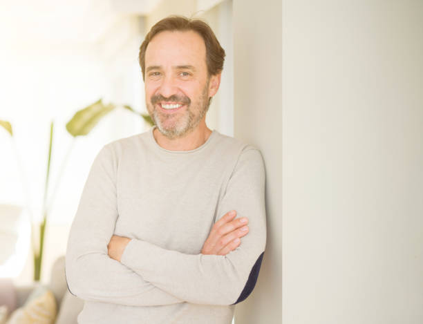 istock Handsome middle age man smiling looking at the camera at home 1134264301