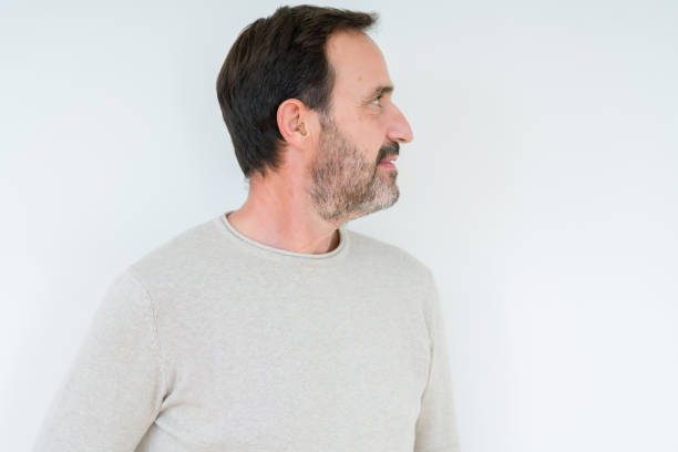 istock Elegant senior man over isolated background looking to side, relax profile pose with natural face with confident smile. 1134265215