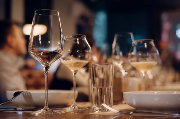istock dinner background with biodynamic wine glasses and plates. 1134266174