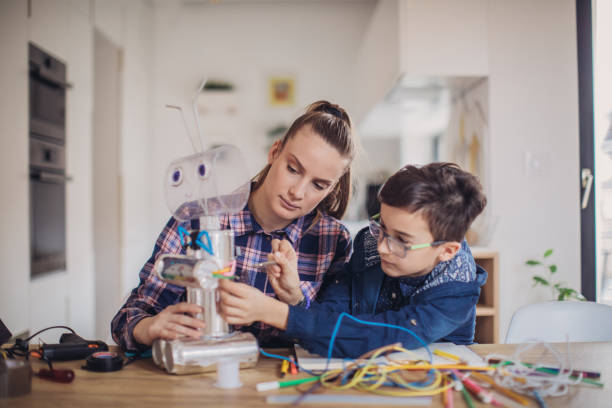 istock Big sister and little brother constructing a robot 1134267203