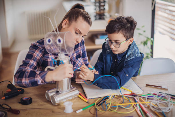 istock Big sister and little brother constructing a robot together 1134267264