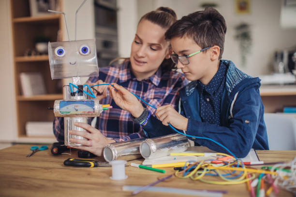istock Big sister and little brother constructing a robot for school science project together 1134267331