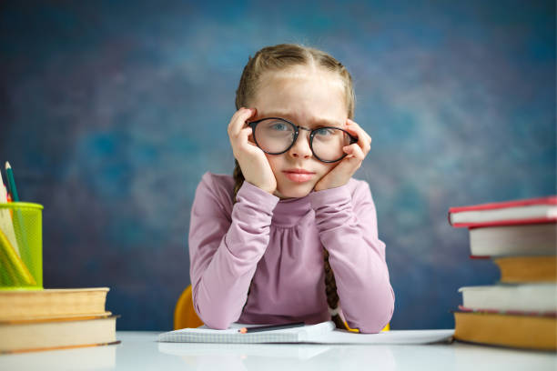 istock Pretty Primary Student Girl Look Tired Study Home 1134268114