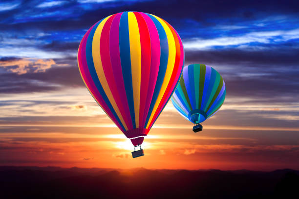 istock Two hot air balloon soar into the sky at sunrise 1134268885