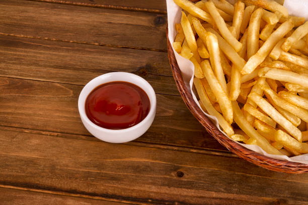 istock French fries in a basket on wooden table. 1134270331