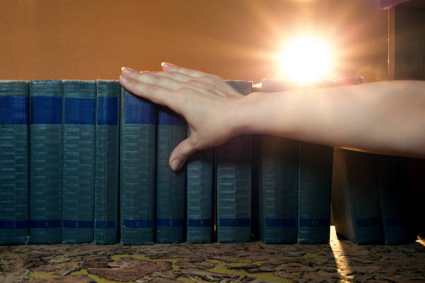 istock Female hand takes from the shelf a books. 1134272882