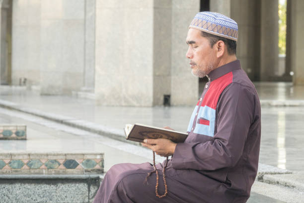 istock Mature Man Reading Koran While Sitting At Mosque 1134273348