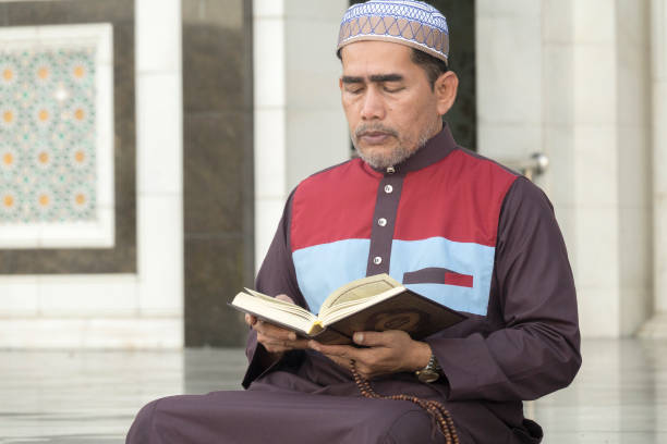 istock Mature Man Reading Koran While Sitting At Mosque 1134273350