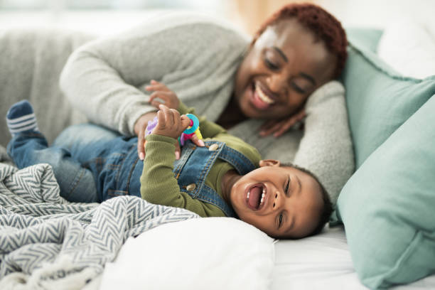 He's definitely ticklish Cropped shot of a mother playing with her adorable baby boy todler care stock pictures, royalty-free photos & images