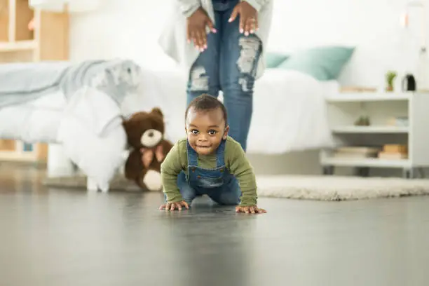 Shot of an adorable baby boy crawling on the floor