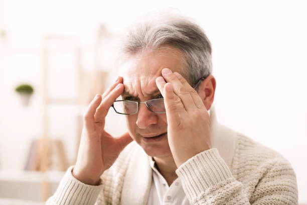 istock Horrible migraine. Sad senior man touching temples 1134275398