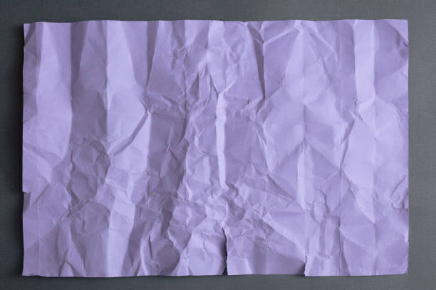 istock Wrinkled Purple paper on gray background 1134276502