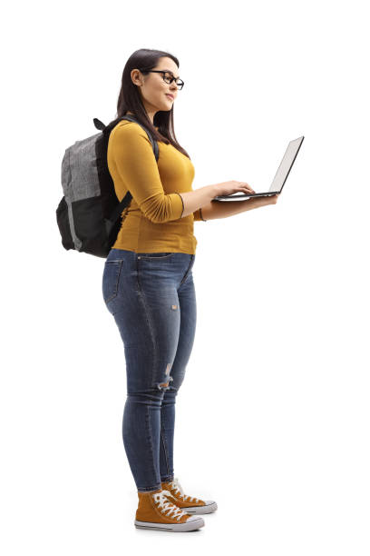 istock Female student with a backpack and laptop standing 1134276797