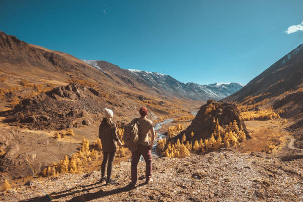 istock Two travelers looks at mountains and valley 1134277015