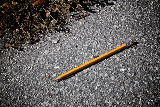 istock yellow pencil on ground from above 1134278387