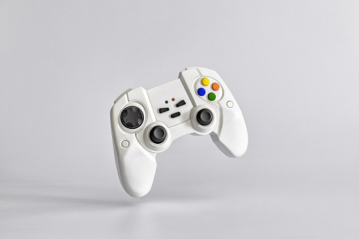 White gamepad on white uniform background. Minimalism. Copy space for text