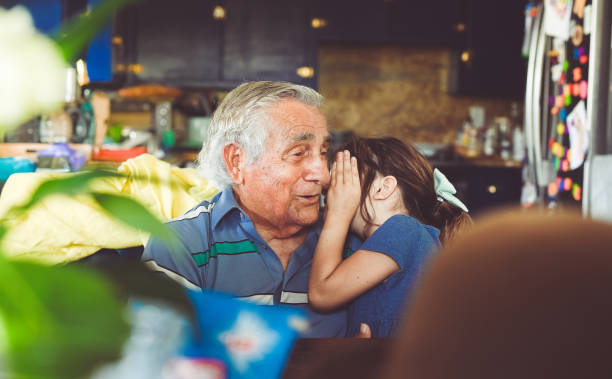 uscire con il bisnonno - whispering grandparent child grandfather foto e immagini stock