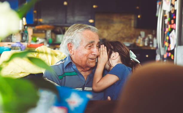 uscire con il bisnonno - whispering grandparent child grandfather foto e immagini stock