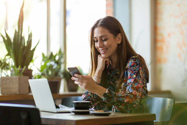 istock Young woman with laptop in cafe 1134280322