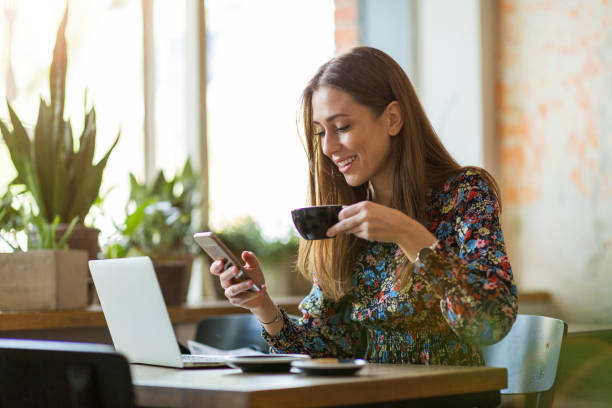istock Young woman with laptop in cafe 1134280941