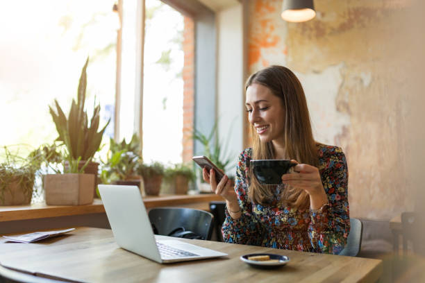 istock Young woman with laptop in cafe 1134280996