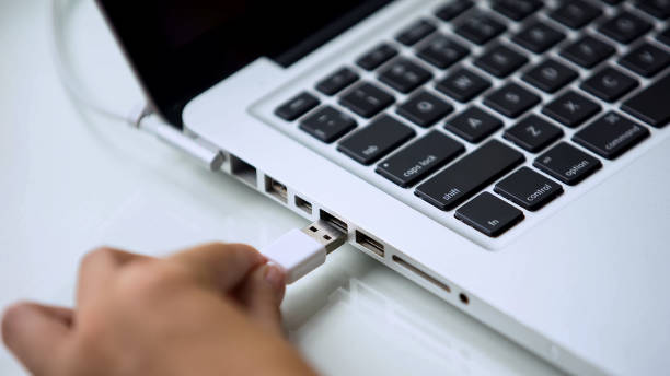 istock Hand connecting usb hard drive to laptop, modern personal computer technology 1134281736