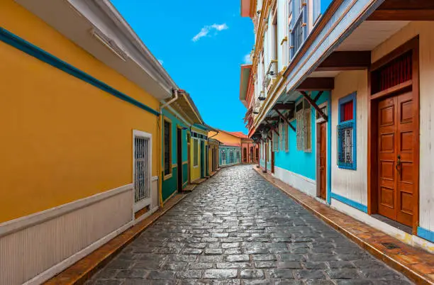 Cityscape in a colorful street of Guayaquil city, famous of its cobblestones and wooden colonial architecture, Las Penas district on Santa Ana Hill, Ecuador.