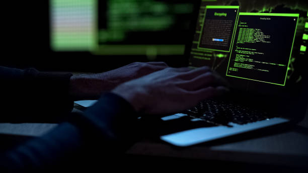 istock Cybercriminal creating malicious software, typing on laptop keypad, closeup 1134282607