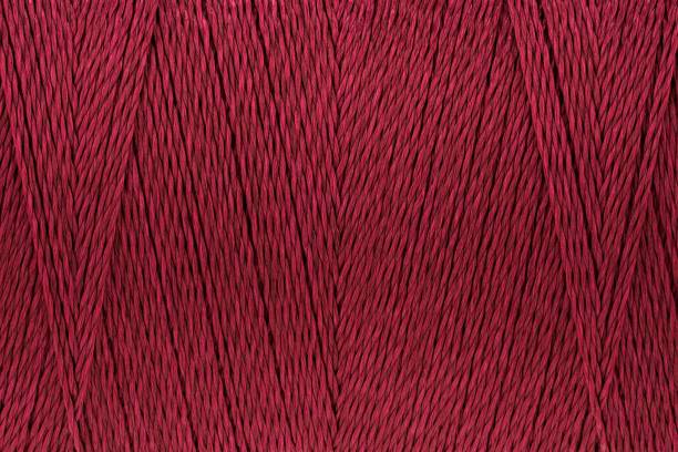 istock Macro picture of thread texture red crimson color background 1134283259