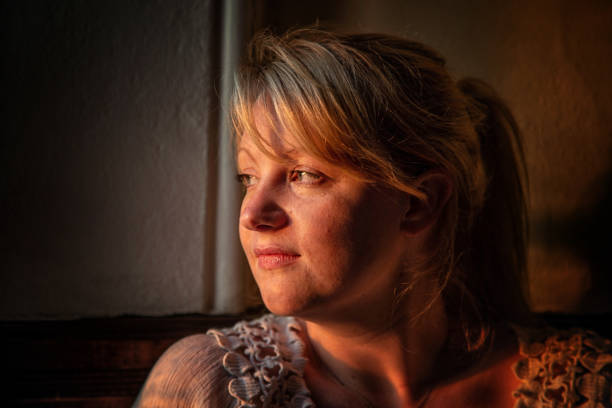 istock beautiful young woman in window light 1134288141