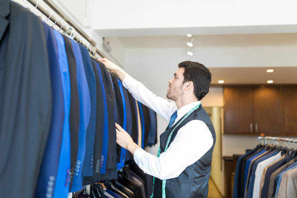 istock Young Tailor Working In Suit Rent Store 1134289151