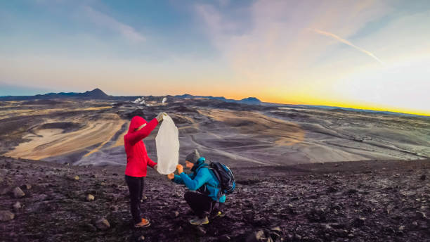 istock Iceland - Couple lighting a wish lantern. 1134289408